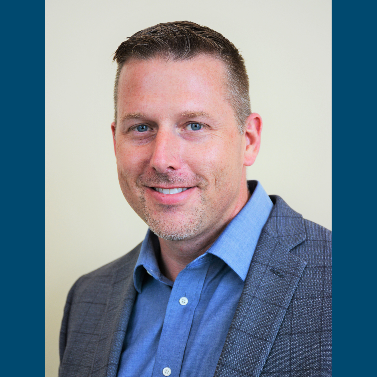 Man in suit with blue shirt